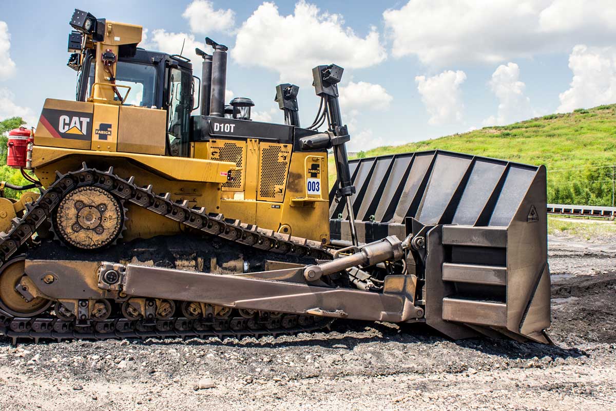Track dozer equipped with a coal U-blade dozer blade designed to carry more coal and reduce spillage
