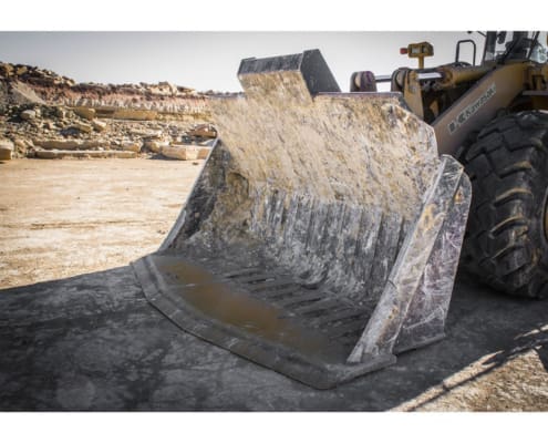 Dymax quarry rock bucket for handling cut stone in a quarry after blocks have been scored and cut