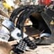 Close-up of Dymax scrap grapple bucket with dual independent top clamp and tine design