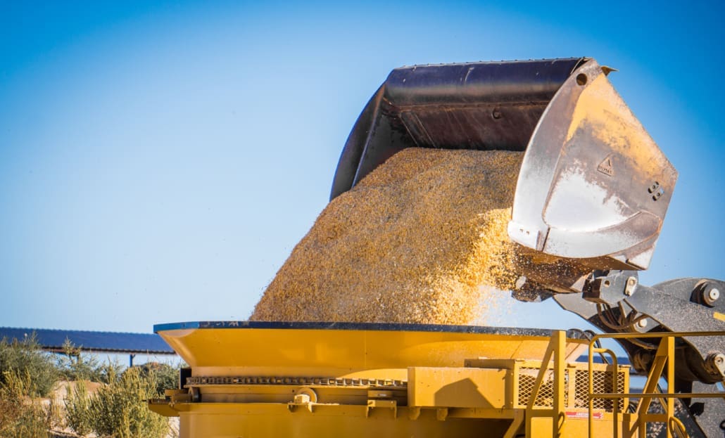 Click to show details - Pushout Bucket Dumping Grain Dymax Pushout wheel loader bucket pushing grain forward for controlled feeding