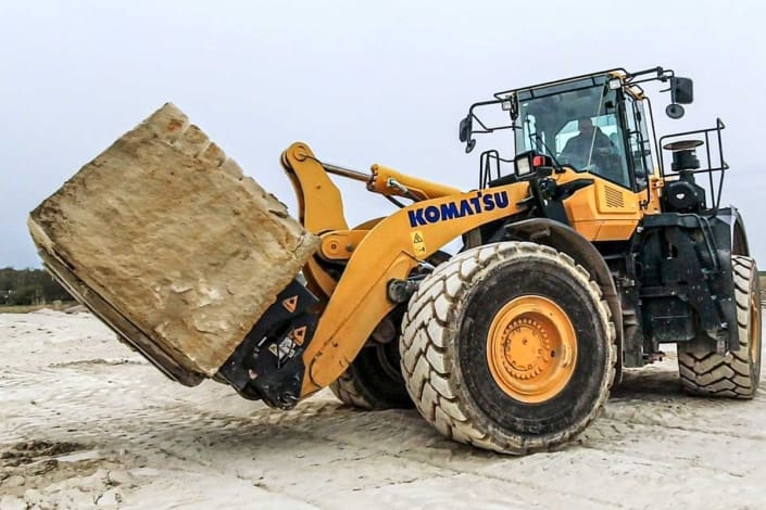 dymax-block-handling-fork-coupler-rock-quarry Block handling fork and coupler moving stone blocks at a rock quarry